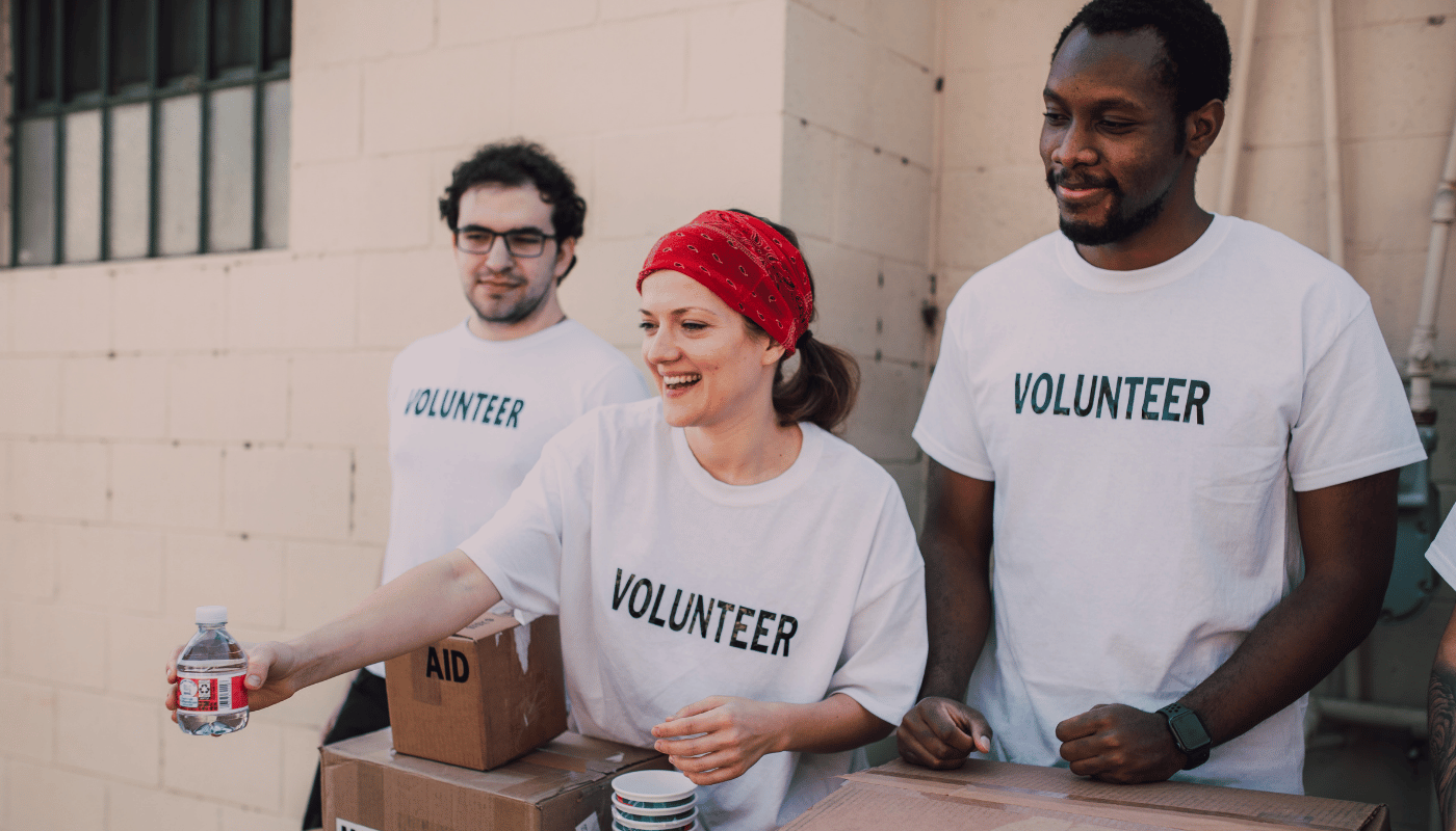 # volunteers sharing aid and bottle of water